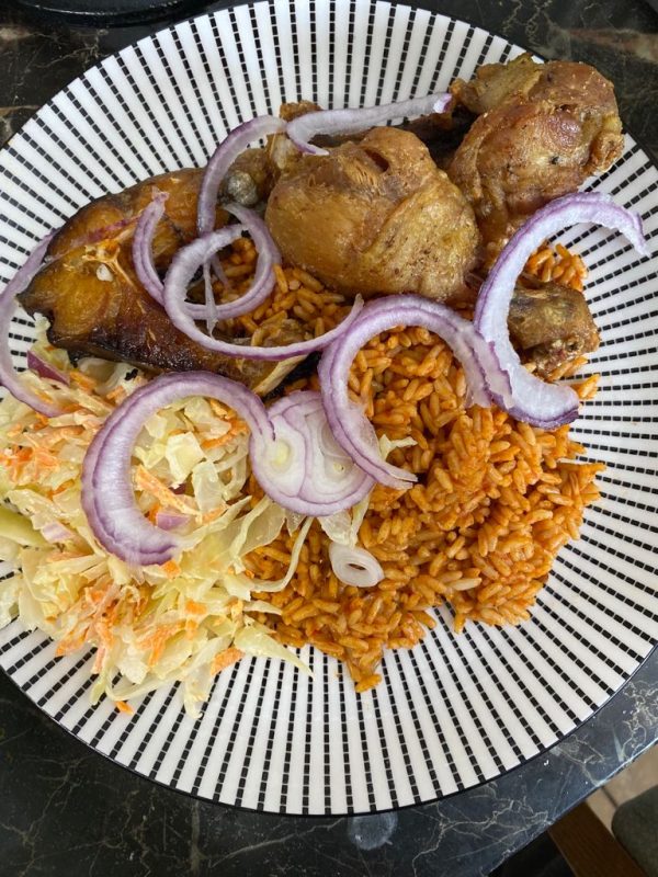 Plate of Jollof Rice with chicken and onions